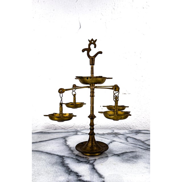 This is a hand made brass oil lamp also known as Panchmukhi Diya in India. It can be unscrewed into 3 pieces and is...