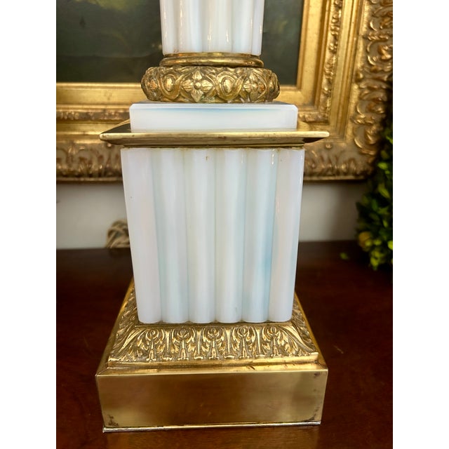 Elegant vintage table lamp featuring a tall, fluted opaline (milk) glass column set on a stepped square base with richly...