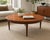 A beautifully restored vintage round coffee table crafted from solid mahogany with a figured mahogany veneer top and...