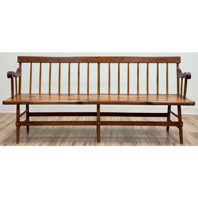 Stunning antique six foot long hand-carved wood deacon's bench. Features a classic spindle back in simplistic shaker...