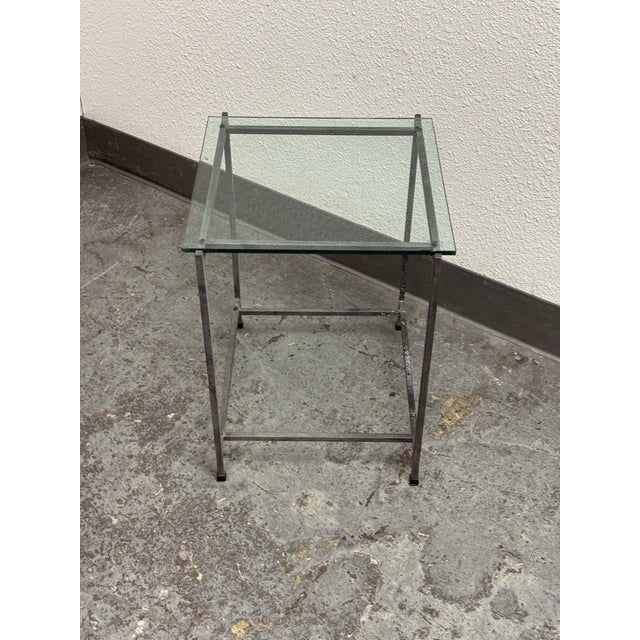Design Plus Gallery presents a Contemporary Glass Top Side Table. A square clear glass panel rests above a slender metal...