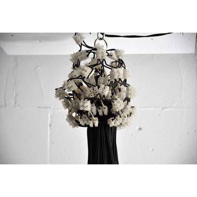 This is a rody graumans 85 lamp for droog design, 1995. It is a highly unique and famous chandelier. This one is an...