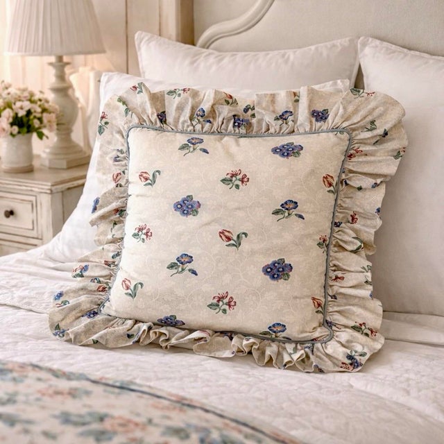 Soft floral print on light white cotton with a subtle tonal scroll background. Fabric is sturdy but not heavy, with a full...