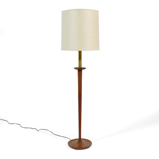 The appeal of this lamp lies in the beautifully sculpted details of its solid walnut base. The neck is cylindrical brass...