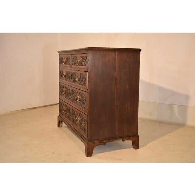 Late 18th century hand carved oak chest of drawers from England. The top is made from two boards, with a molded and...