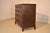 Late 18th century hand carved oak chest of drawers from England. The top is made from two boards, with a molded and...
