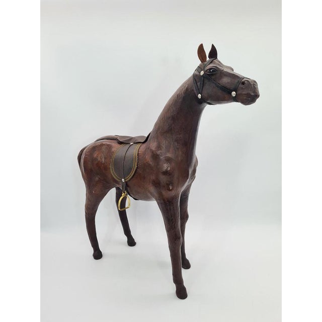 An impressive figure depicting a horse, made of a molded body covered with natural leather. The decoration is kept in a...