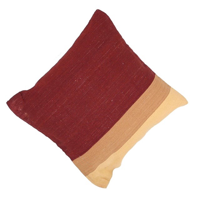 A one-of-a-kind handwoven wool kilim floor pillow featuring a deep burgundy color-block with a cream stripe. Fully...