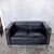 A striking mid-century modern two-seater sofa inspired by the timeless lc2 seating collection designed by le corbusier,...
