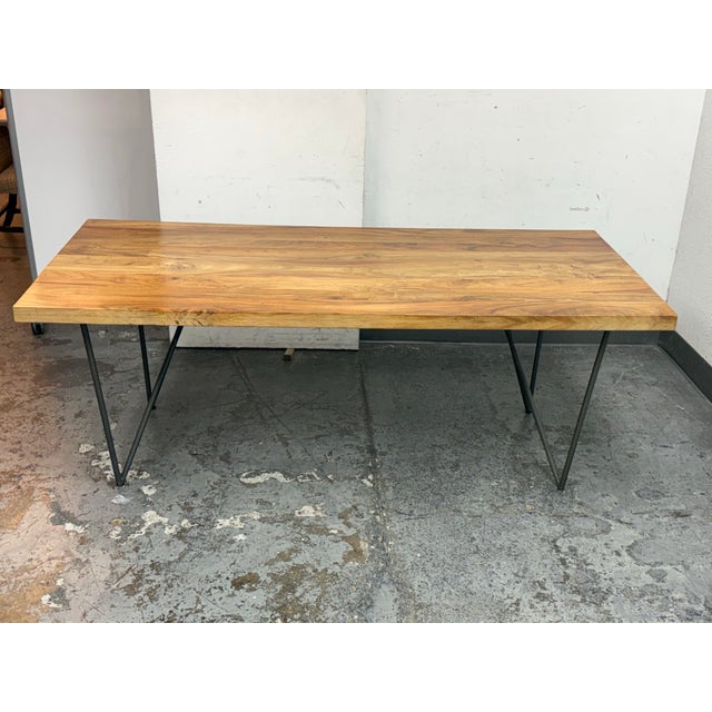 Design Plus Gallery presents the Dylan Acacia Dining Table from CB2. The thick acacia slab wood top has natural grain...