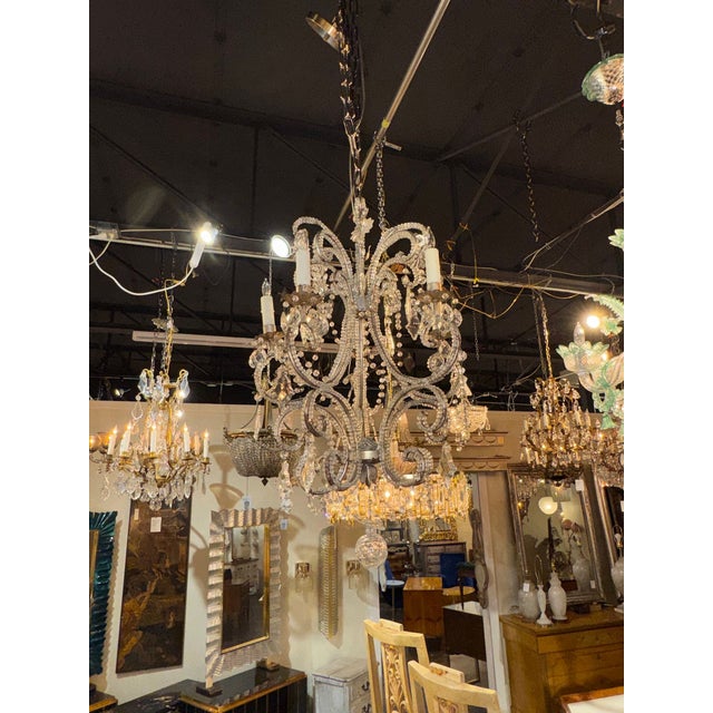 The product is an early 20th century Italian beaded crystal chandelier, likely featuring intricate designs and...