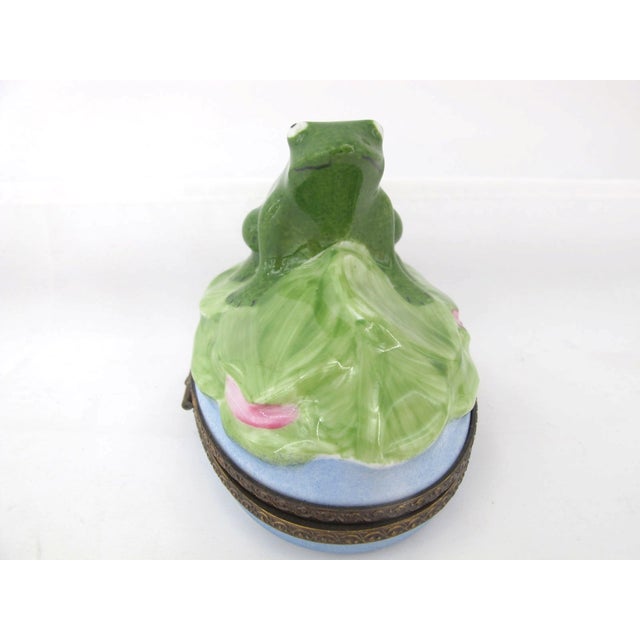Sweet as can be porcelain Limoges France hinged trinket box. A big green frog sits upon his personal lily pad. This is a...