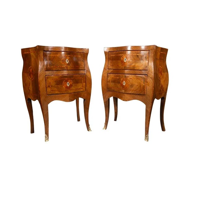 Serpentine top over bombe form two drawers and sides, cabriole legs. Bronze feet.