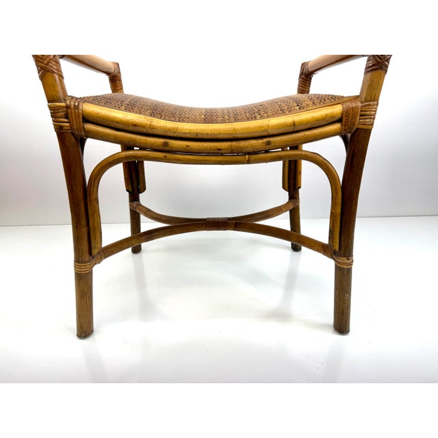 A charming vintage rattan bench showcasing bentwood craftsmanship and warm honey tones. The gently curved frame is wrapped...