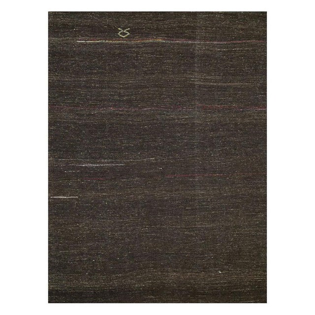A vintage Turkish flat-weave Kilim accent rug handmade during the mid-20th century with a tribal aesthetic in brown with...