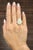 This exquisite ring is a true statement piece, showcasing a breathtaking 7.79 carat natural Australian Opal as its...