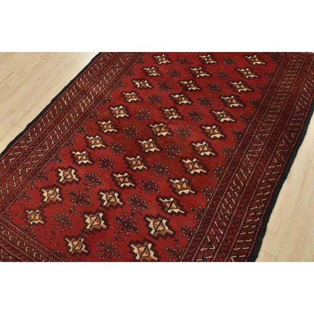 An authentic vintage tribal Turkmen rug hand-knotted with fine wool and natural dyes. This rug features repeating rows of...