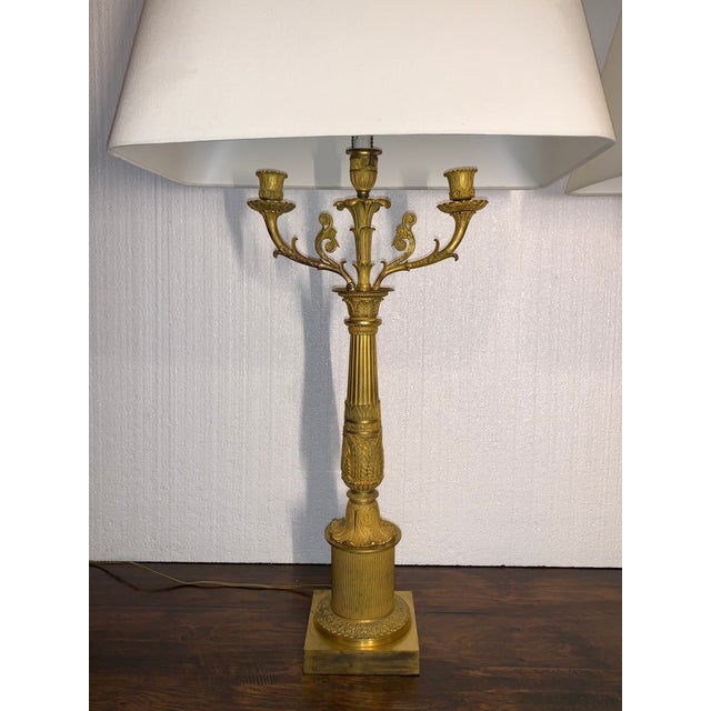 Fine pair of three light gilt bronze French Empire Candelabra now mounted as table lamps. Circa 1820-1850.