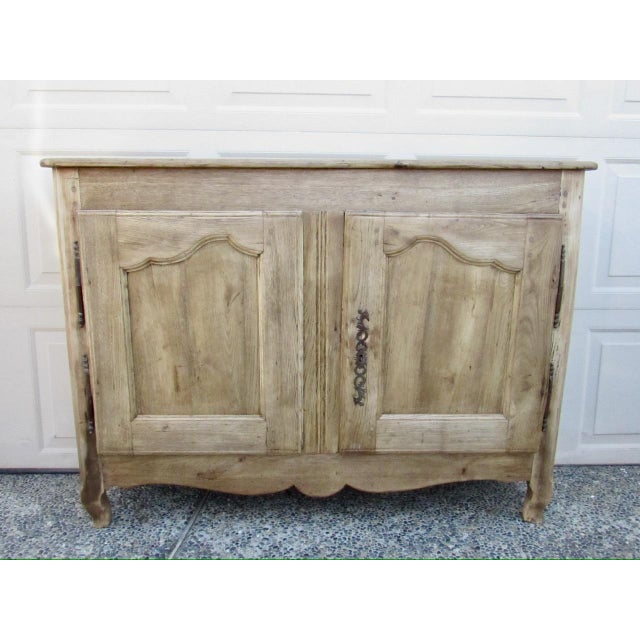 19th century French weathered oak buffet, c.1850 Having a molded rectangular top below which are two cupboard doors and...