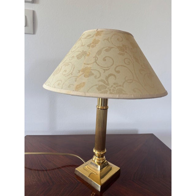 A magnificent Empire-style bedside lamp, where polished gilt brass reveals all the elegant rigor of the Neoclassical...