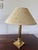 A magnificent Empire-style bedside lamp, where polished gilt brass reveals all the elegant rigor of the Neoclassical...