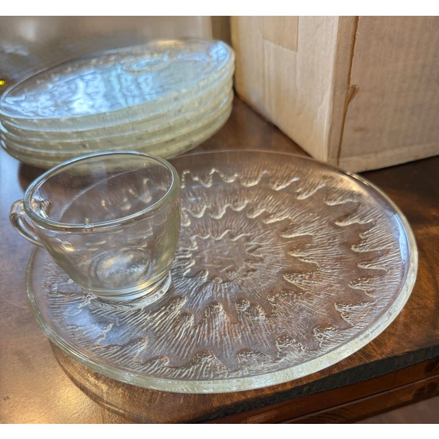 This elegant set of 12 snack plates and 12 cups features the “Sunburst“ pattern radiating from the center. The clear...