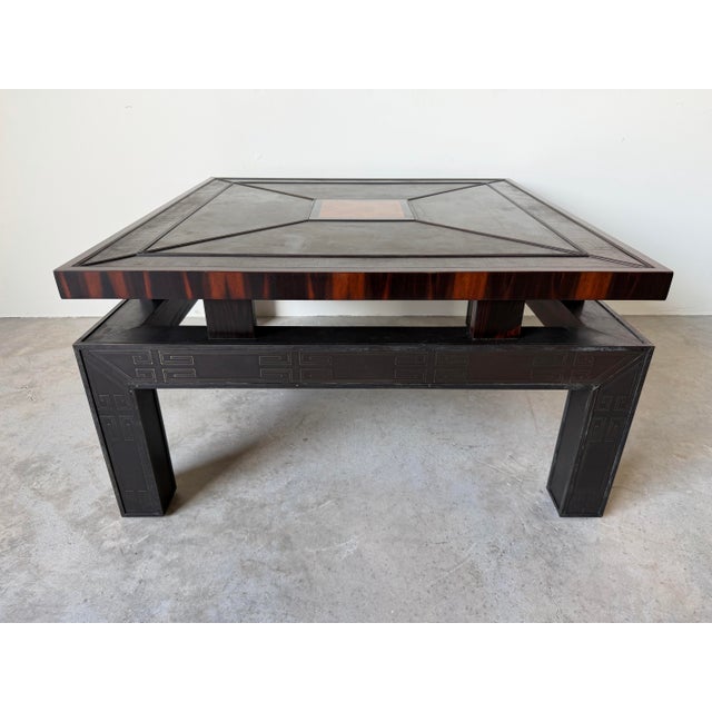 A striking vintage Hollywood Regency coffee table featuring an elegant Asian-inspired design with engraved Greek Key...