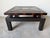 A striking vintage Hollywood Regency coffee table featuring an elegant Asian-inspired design with engraved Greek Key...