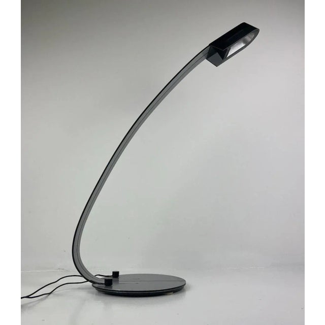 Elegant table lamp designed by Ewald Winkelbauer for Tronconi in 1980. Featuring an aluminum body and a black plastic...