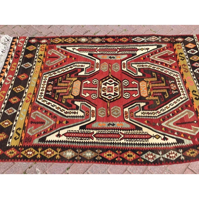 This beautiful, traditional vintage, flatweaved Turkish kilim rug is approximately 60 years old. It is handmade of very...