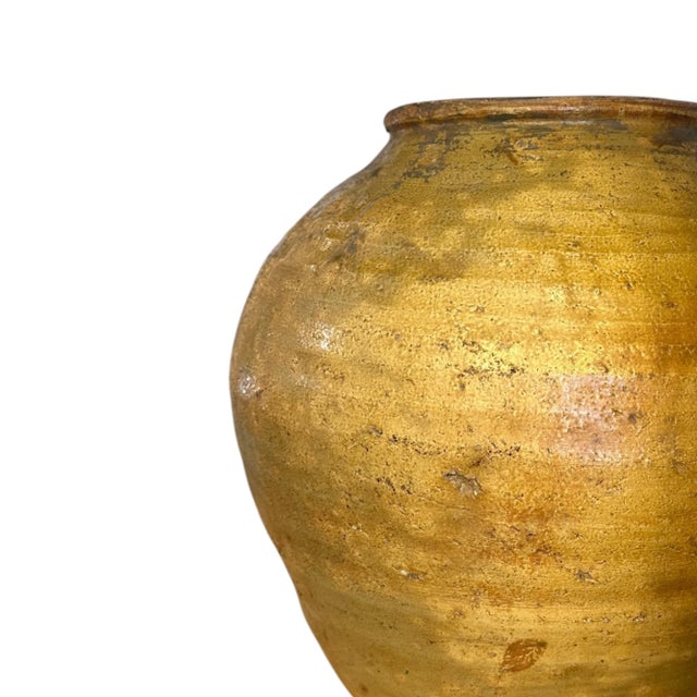 A piece of Indonesian daily life, preserved in clay. This vintage vase was handcrafted by local artisans using traditional...