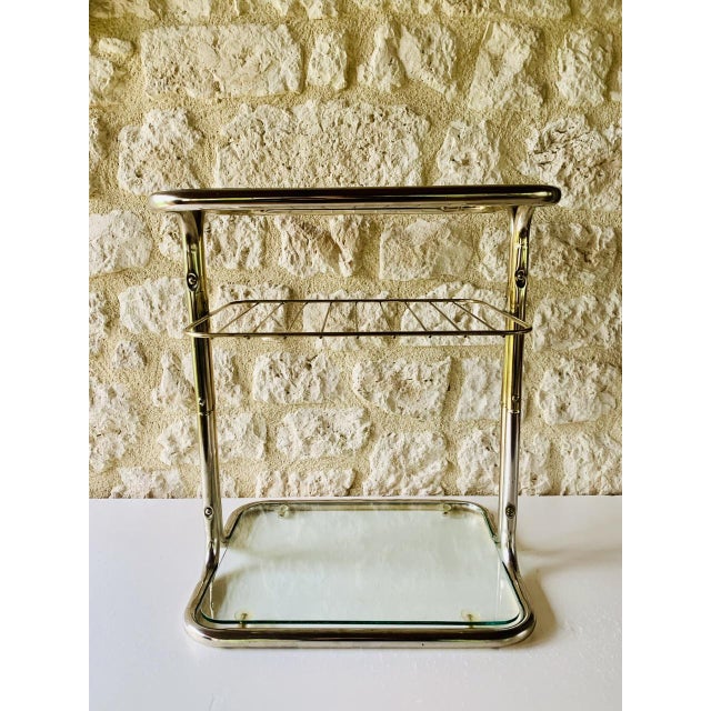 Vintage, mid-century, two -tiered, side table/end table, with magazine rack from the 1970s. the structure has a sleek...