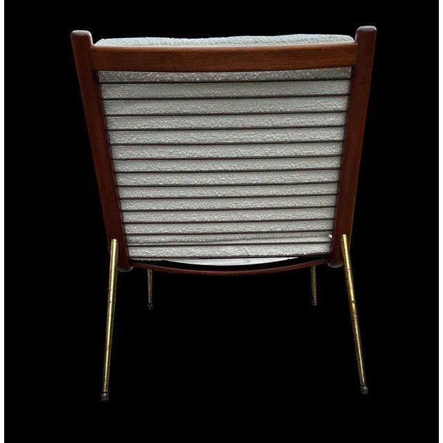 This is a very good original example of this classic chair, freshly upholstered in white boucle. This piece has an...