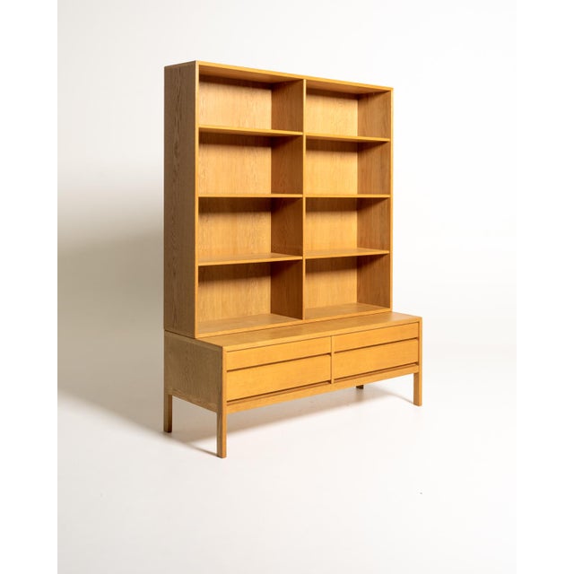 Oak bookcase composed of an upper module with adjustable shelves and a separate base with four large drawers. Scandinavian...