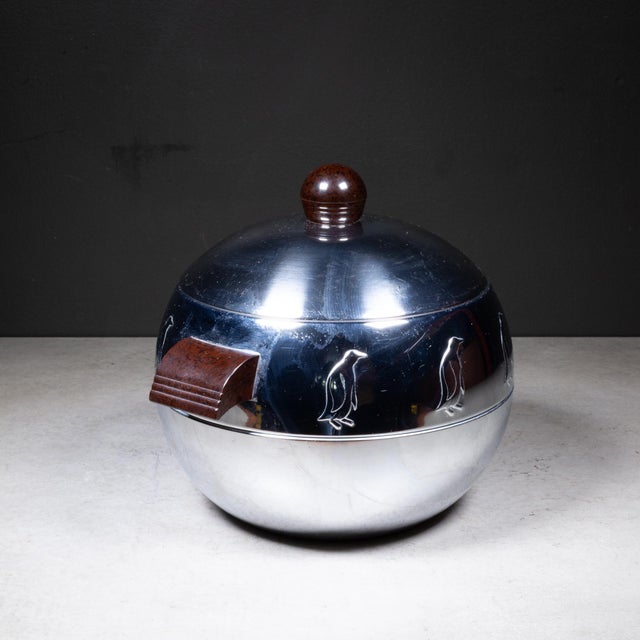 ABOUT Mid-century Penguin ice bucket with brown Bakelite handles and lid knob. Mostly used as ice bucket, but the piece...