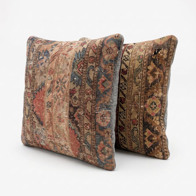 This 24'' x 24'' pillow cover set was made from authentic Turkish rug pieces — vertical faded bands in terracotta and blue...