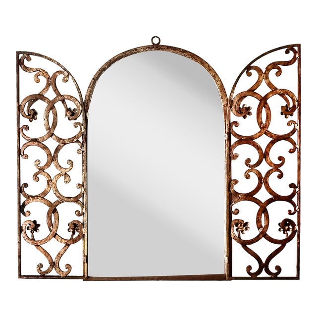 Vintage gilt Italian wall mirror with decorative doors. Mirror at center with folding flat metal decorative doors. stamped...