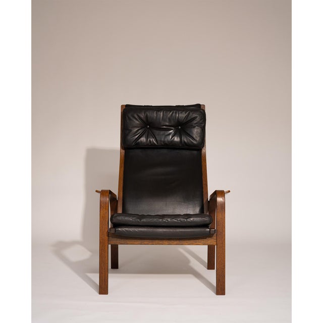 Pair of lounge chairs by Yngve Ekström for Swedese, Sweden, 1970s. Featuring sculptural plywood frames in rich wengé...