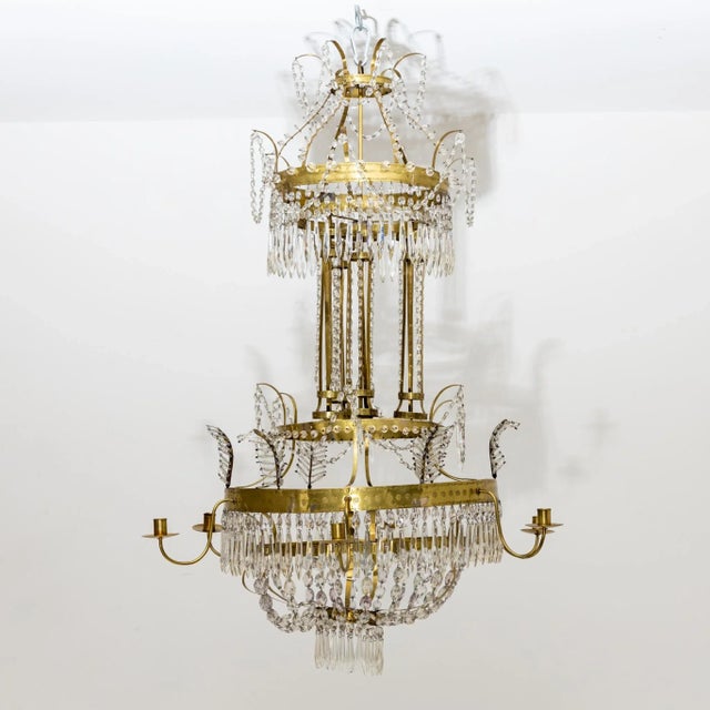 Large brass ceiling chandelier with rich crystal hangings and six arms with candle grommets. Up to 250V (Europe/UK...