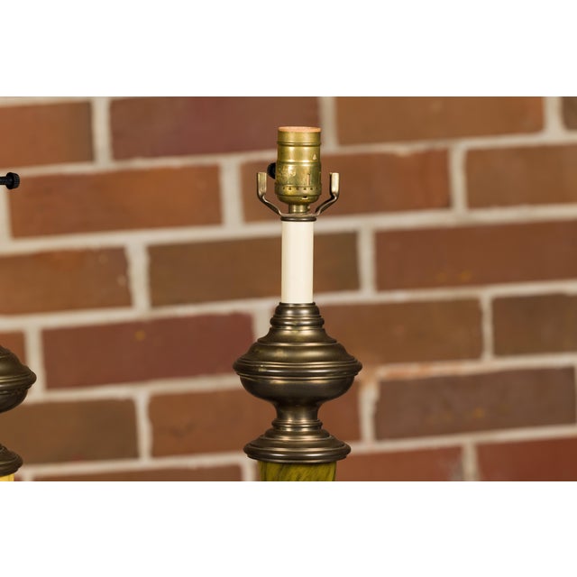 A pair of Chapman 1970s faux horn table lamps with brass bases. This exquisite pair of Chapman 1970s table lamps exudes a...