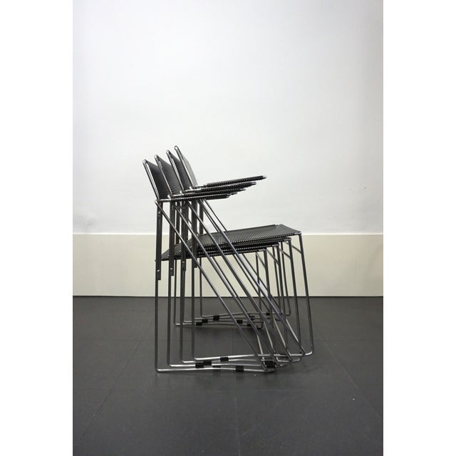 Set of four stackable chairs with armrests designed by Niels Jørgen Haugesen in 1977 for Hybodan. After completing his...