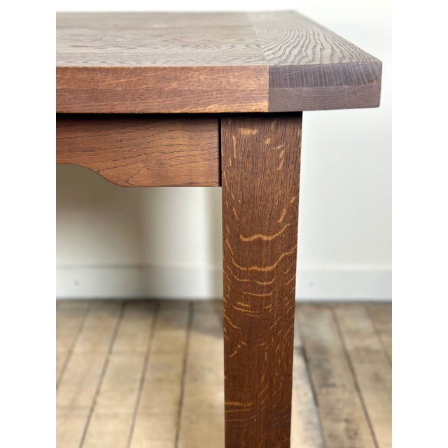Brutalist table with two extension leaves in solid oak. Beautiful French craftsmanship from the 1990s. The tabletop rests...