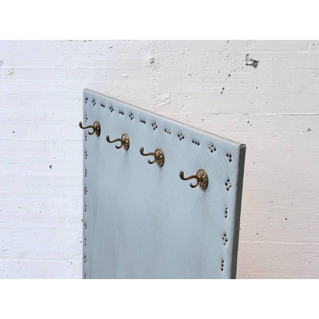 Decorative vintage wall-mounted coat rack with a slim, vertical design and attractive combination of materials. The front...