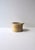 A matte ceramic ice bucket (or bowl pot) with scallop seashell design around. Piece is varying hues of beige/sand with a...
