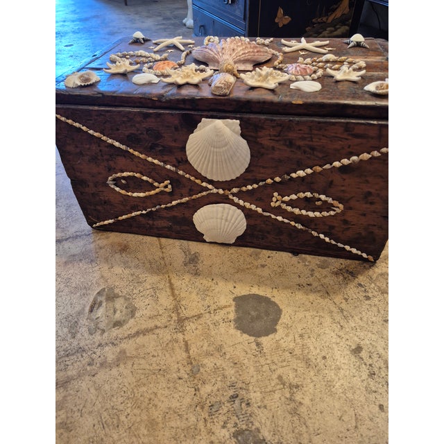 Standout 19th Century folk art wood box lovingly decorated with exotic seashells in an eccentric composition.