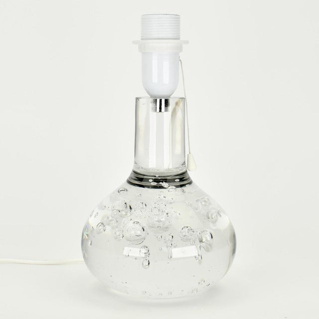 Beautiful solid glass table-lamp with enclosed bubbles. This lamp is designed by Floris Meydam ca.1975, executed by Royal...