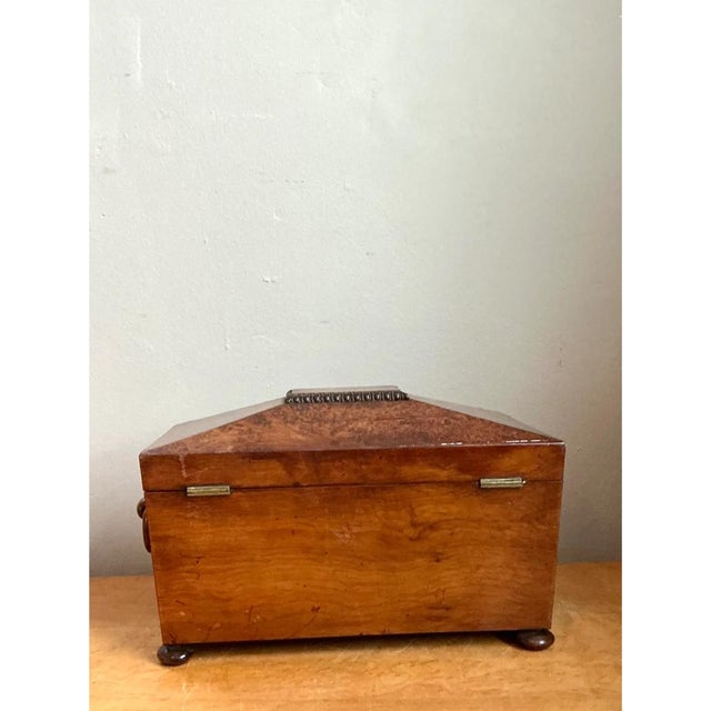 This vintage decorative box takes a distinctive sarcophagus-style silhouette, its sloped, pyramidal lid rising...