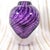 This is a purple cased or someroso perfume bottle with purple swirled lines in a clear bottle. It has a clear teardrop...