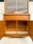 Here is a wonderful china cabinet from the mid-century featuring both open display areas and closed storage in a warm,...
