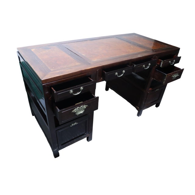 Gorgeous antique Chinese Ming style dark wood desk with reddish burl accents on the top face and a matching foot rest....